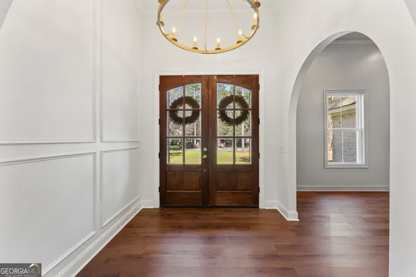 an entryway door with wooden floor
