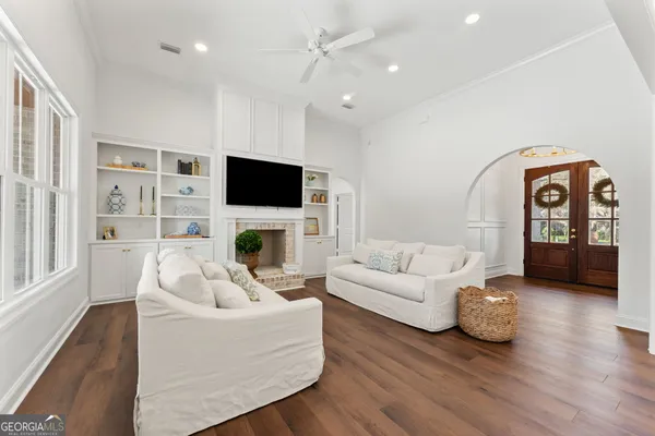 a living room with furniture a fireplace and a flat screen tv