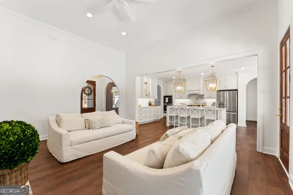 a living room with furniture or kitchen view and a wooden floor