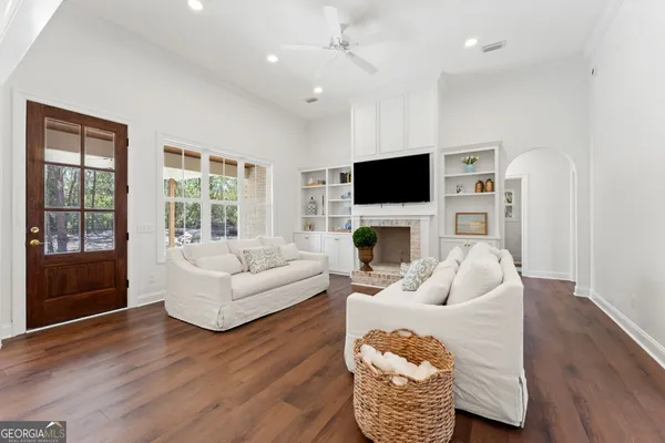 a living room with furniture a fireplace and a flat screen tv