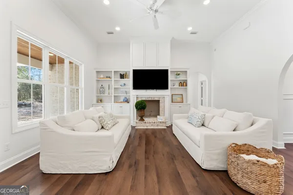 a living room with furniture fireplace and flat screen tv