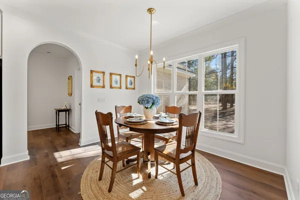 a view of a dining room with furniture window and wooden floor