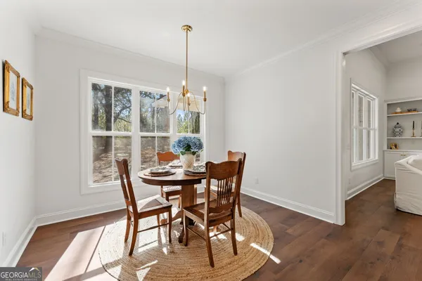 a view of a dining room with furniture window and wooden floor