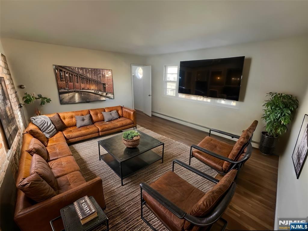 316 John Street, Unit 2 Harrison, NJ 07029 - Photo 2 of 7 a living room with furniture and a flat screen tv