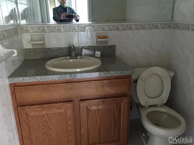 a bathroom with a toilet sink and mirror