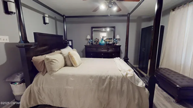 a bedroom with a bed and a mirror on dresser