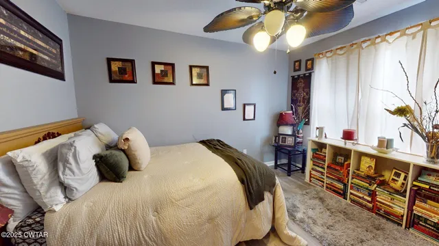 a bedroom with a bed and a chandelier