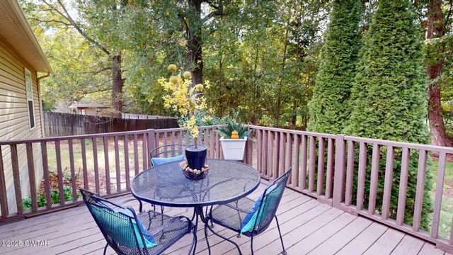 a view of a deck with a table and chairs