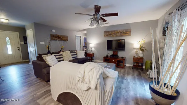 a living room with furniture a fireplace and wooden floor