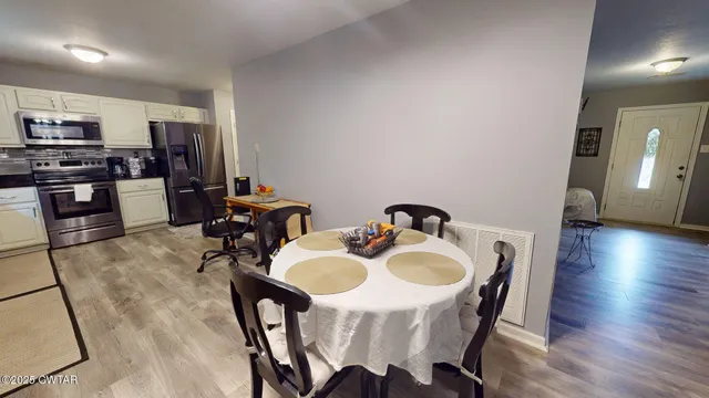 a dining room with furniture and wooden floor