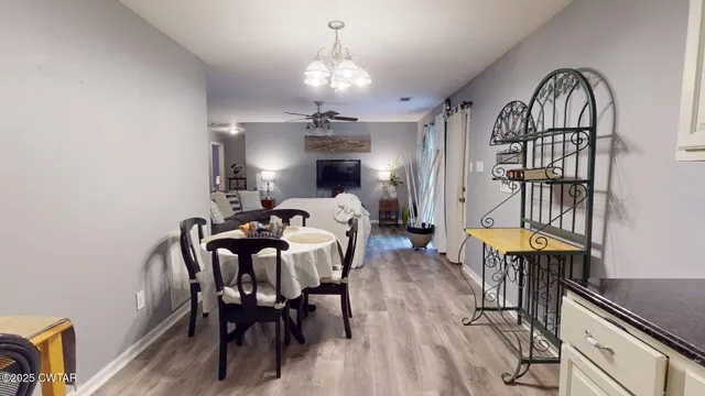 a view of a a dining room with furniture window and wooden floor
