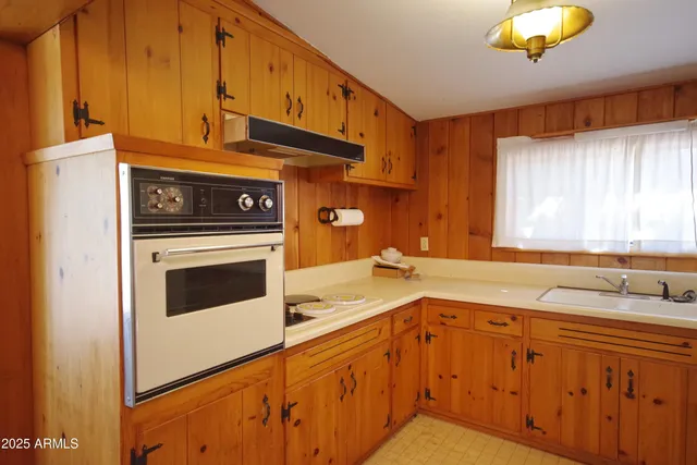 a kitchen with granite countertop cabinets stainless steel appliances and a sink