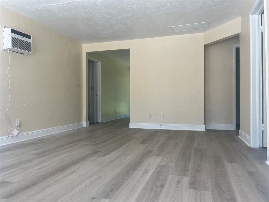 5641 Sheridan Street Hollywood, FL 33021 - Photo 2 of 13 an empty room with wooden floor & closet area