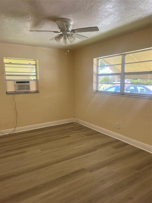 5641 Sheridan Street Hollywood, FL 33021 - Photo 5 of 13 a view of an empty room with wooden floor and a window