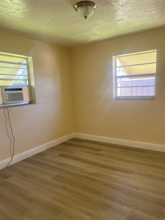 5641 Sheridan Street Hollywood, FL 33021 - Photo 6 of 13 a view of an empty room with wooden floor and a window
