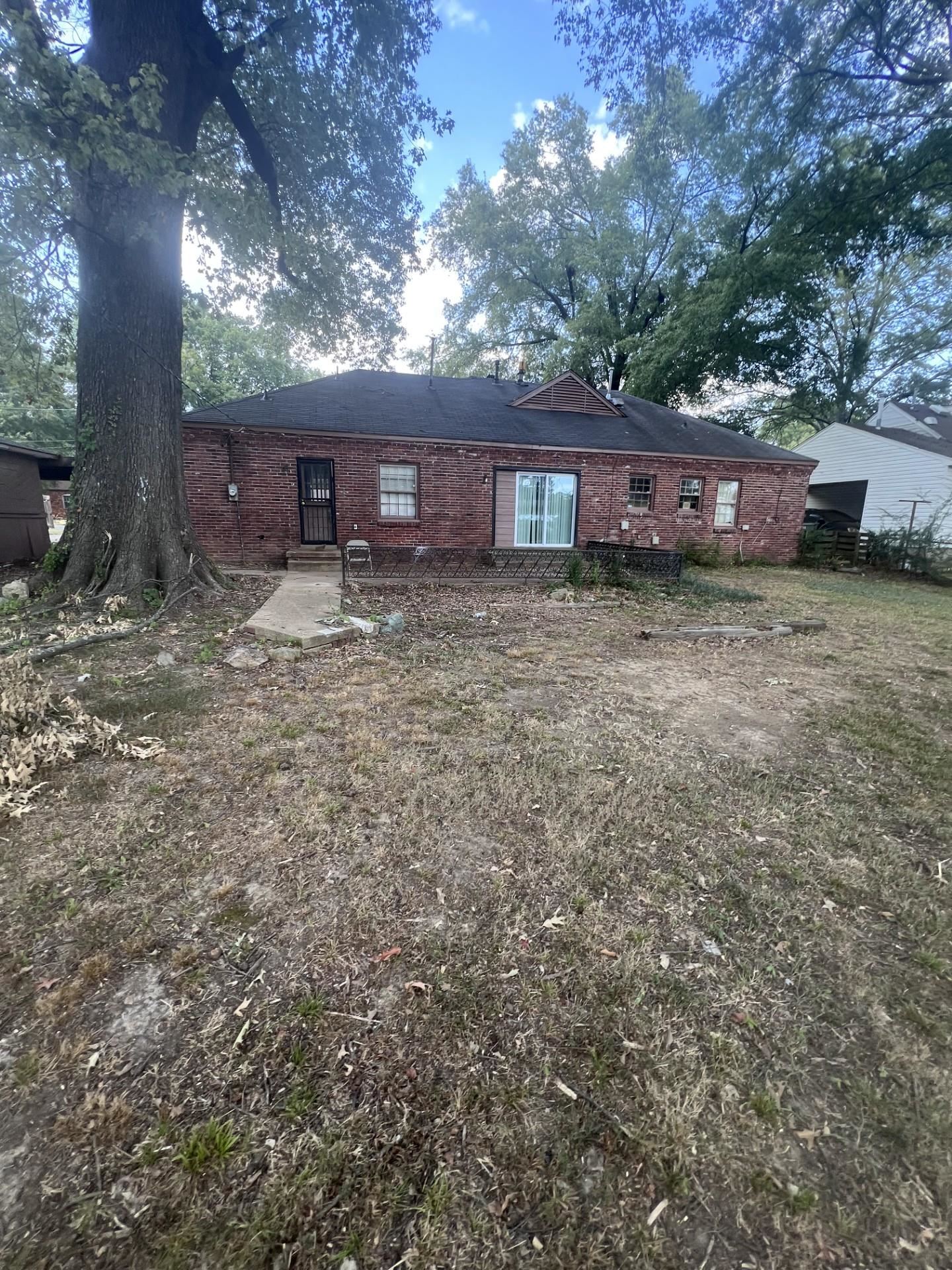3553 Rhodes Avenue Memphis, TN 38111 - Photo 13 of 14 a large tree in front of a house