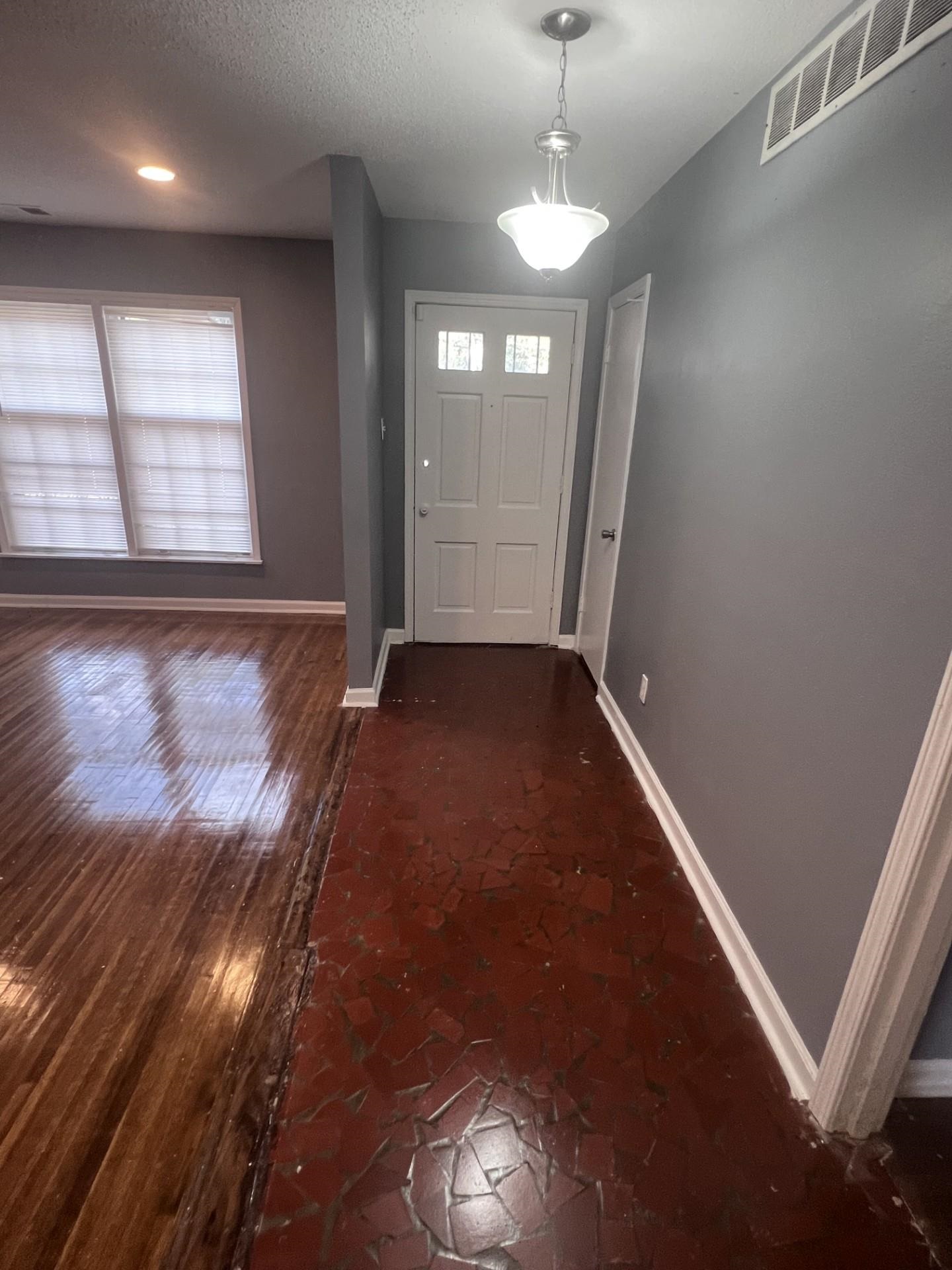 3553 Rhodes Avenue Memphis, TN 38111 - Photo 2 of 14 an empty room with wooden floor and windows