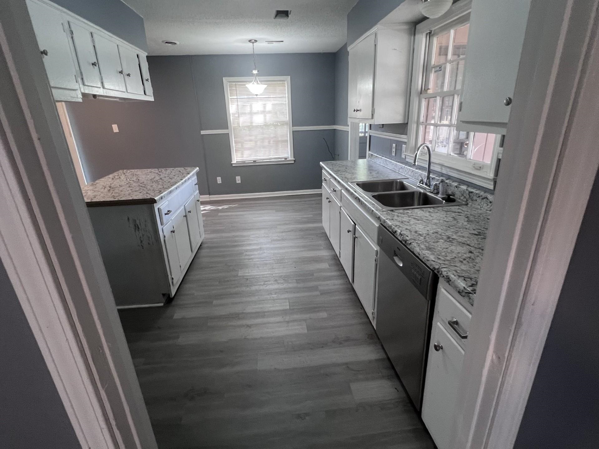 3553 Rhodes Avenue Memphis, TN 38111 - Photo 6 of 14 a kitchen with granite countertop a sink stove and refrigerator