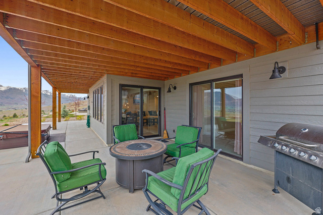 4527 North Seven Bridges Road Eden, UT 84310 - Photo 52 of 65 View of patio / terrace with a fire pit, a mountain view, and area for grilling
