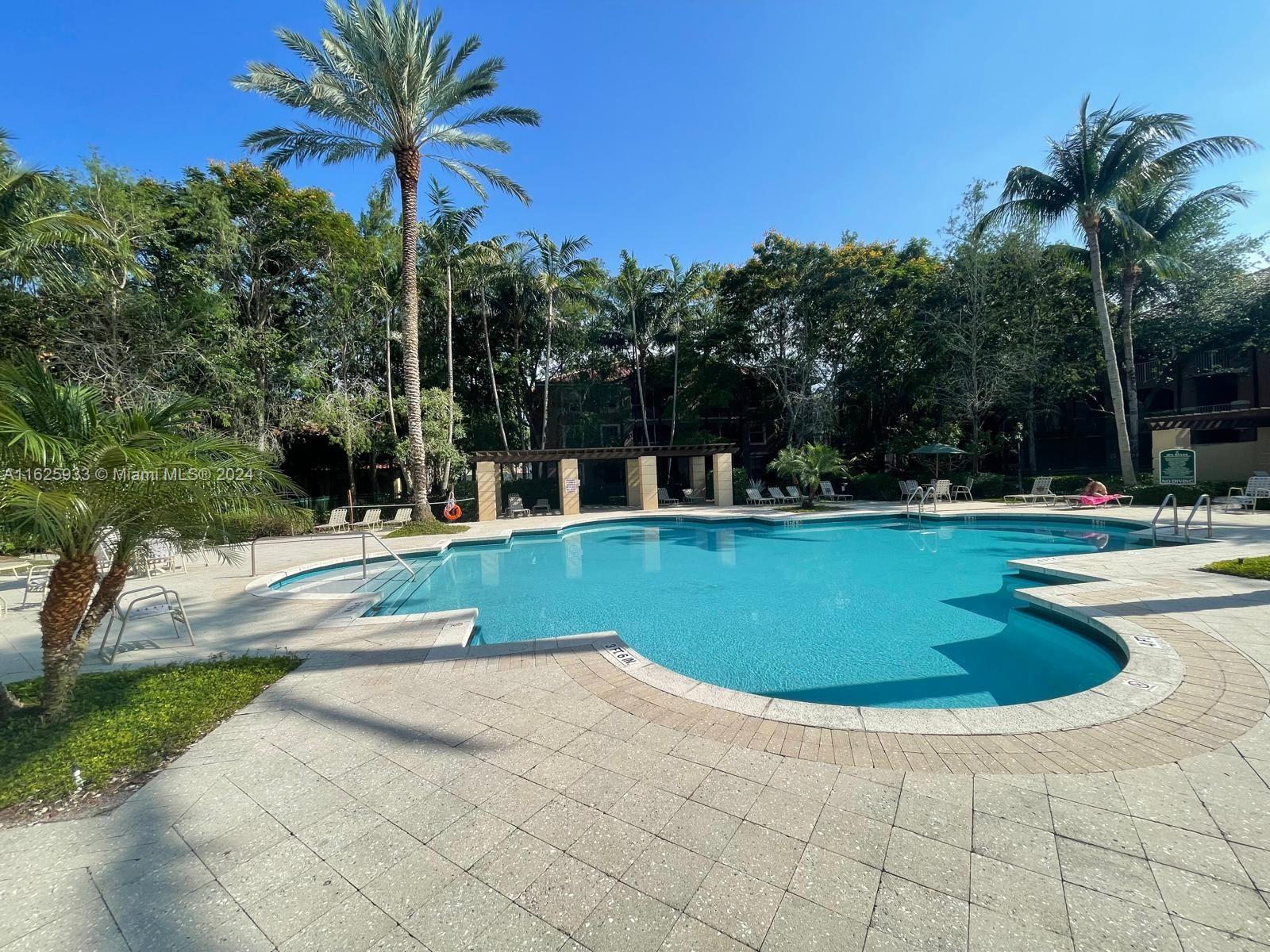 6912 West Sample Road, Unit 6912 Pompano Beach, FL 33063 - Photo 18 of 27 a view of outdoor space yard swimming pool and patio