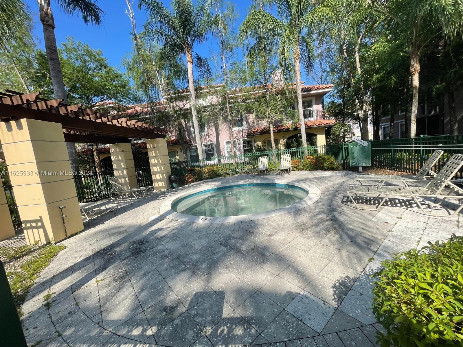 6912 West Sample Road, Unit 6912 Pompano Beach, FL 33063 - Photo 20 of 27 a view of a swimming pool with a patio