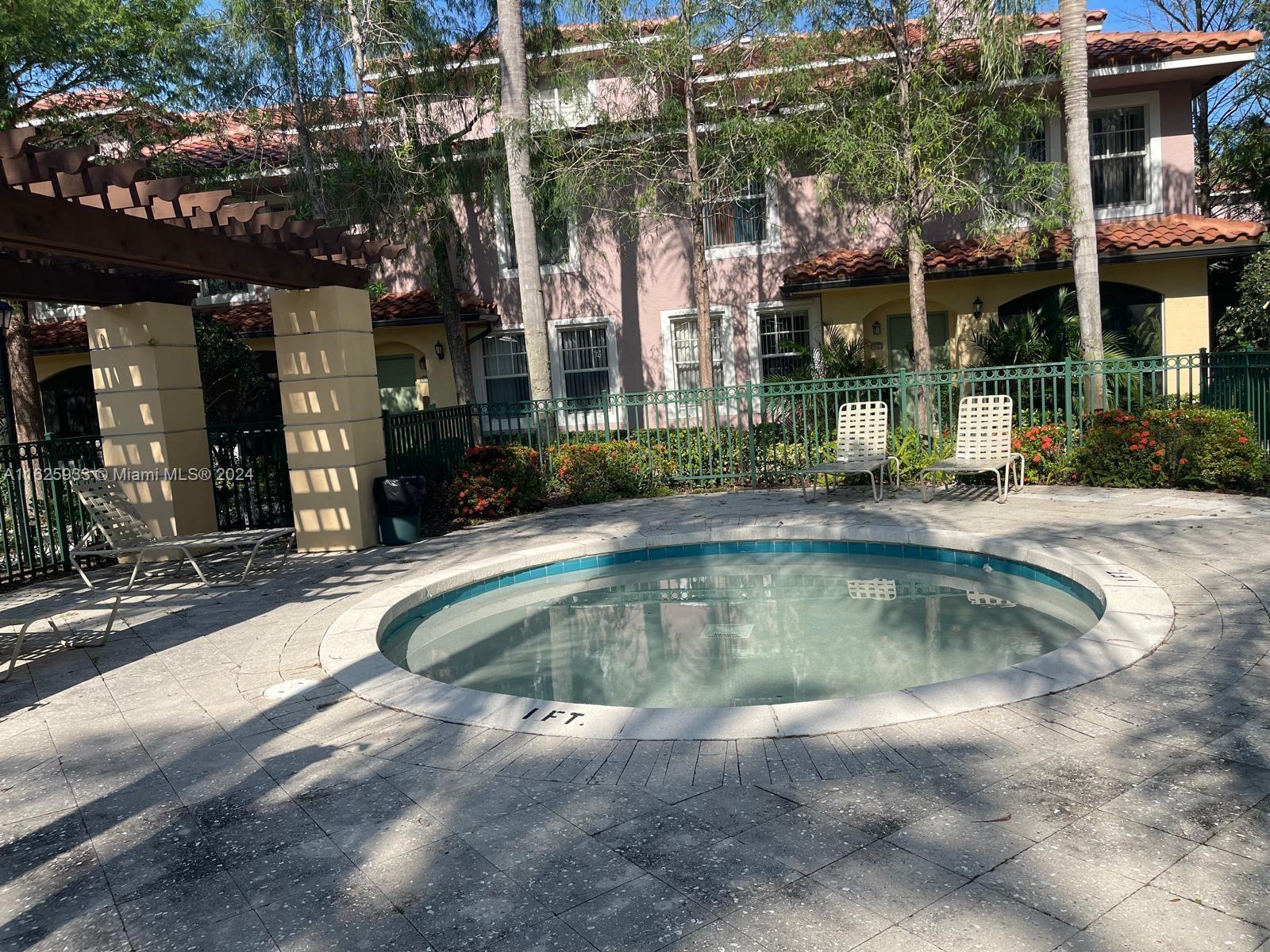 6912 West Sample Road, Unit 6912 Pompano Beach, FL 33063 - Photo 21 of 27 a view of a house with swimming pool