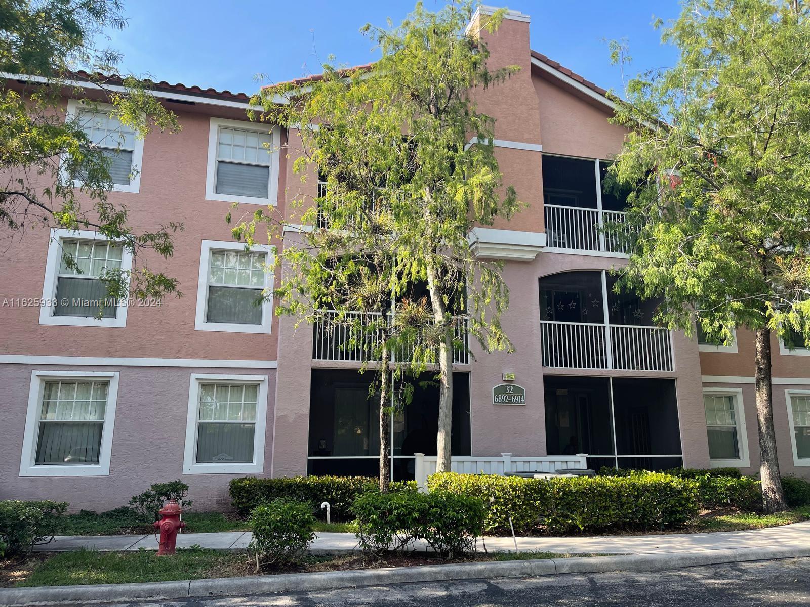 6912 West Sample Road, Unit 6912 Pompano Beach, FL 33063 - Photo 3 of 27 front view of a house