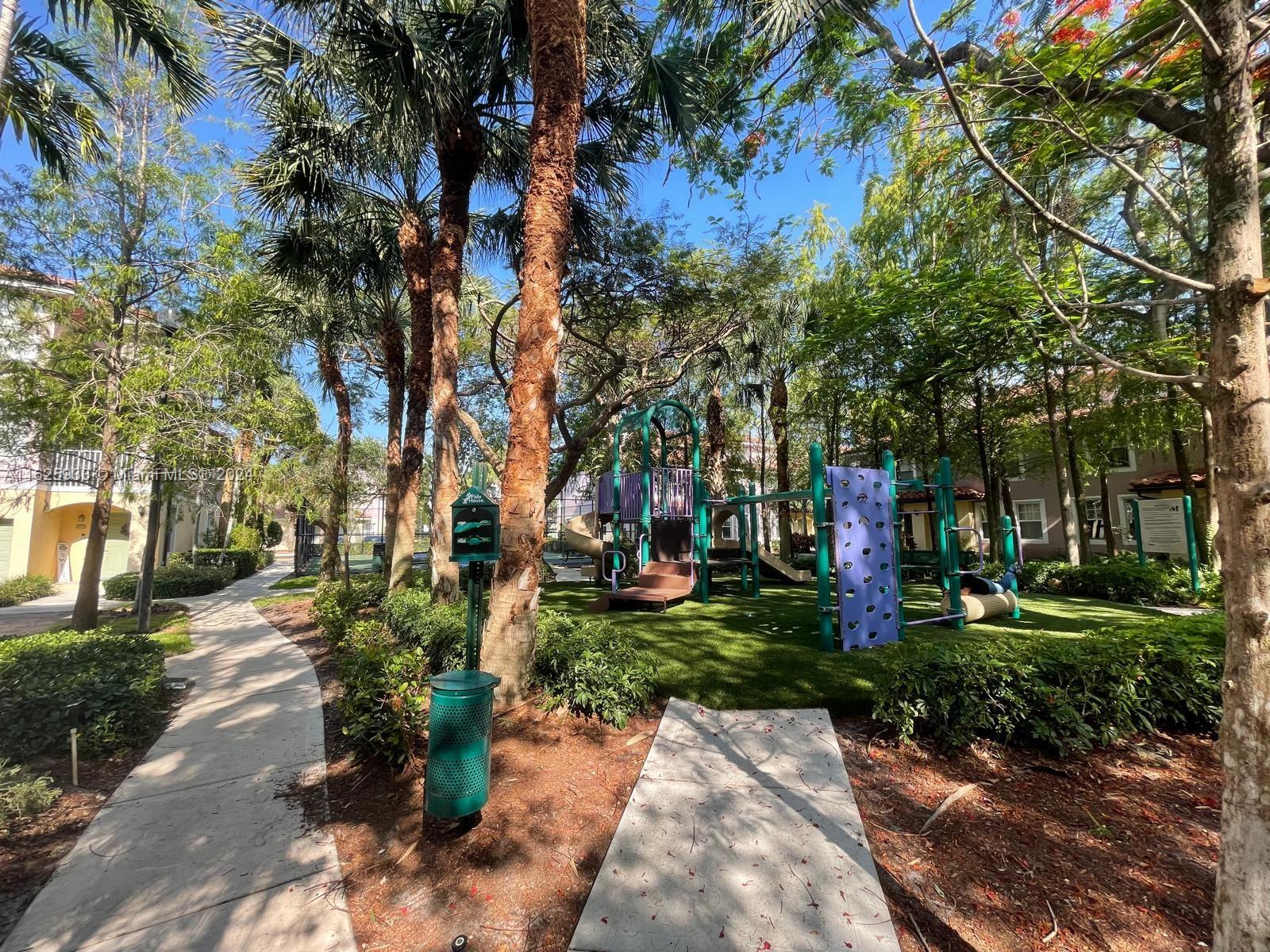 6912 West Sample Road, Unit 6912 Pompano Beach, FL 33063 - Photo 7 of 27 a view of a park with large trees
