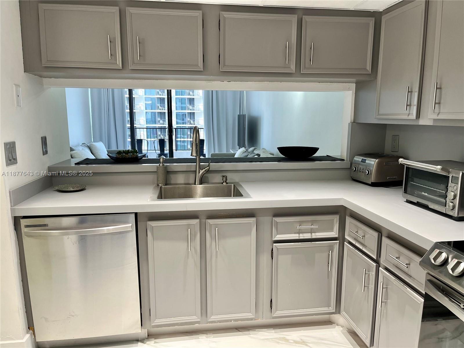 555 Northeast 15th Street, Unit 15G Miami, FL 33132 - Photo 37 of 61 a kitchen with stainless steel appliances granite countertop a sink and cabinets