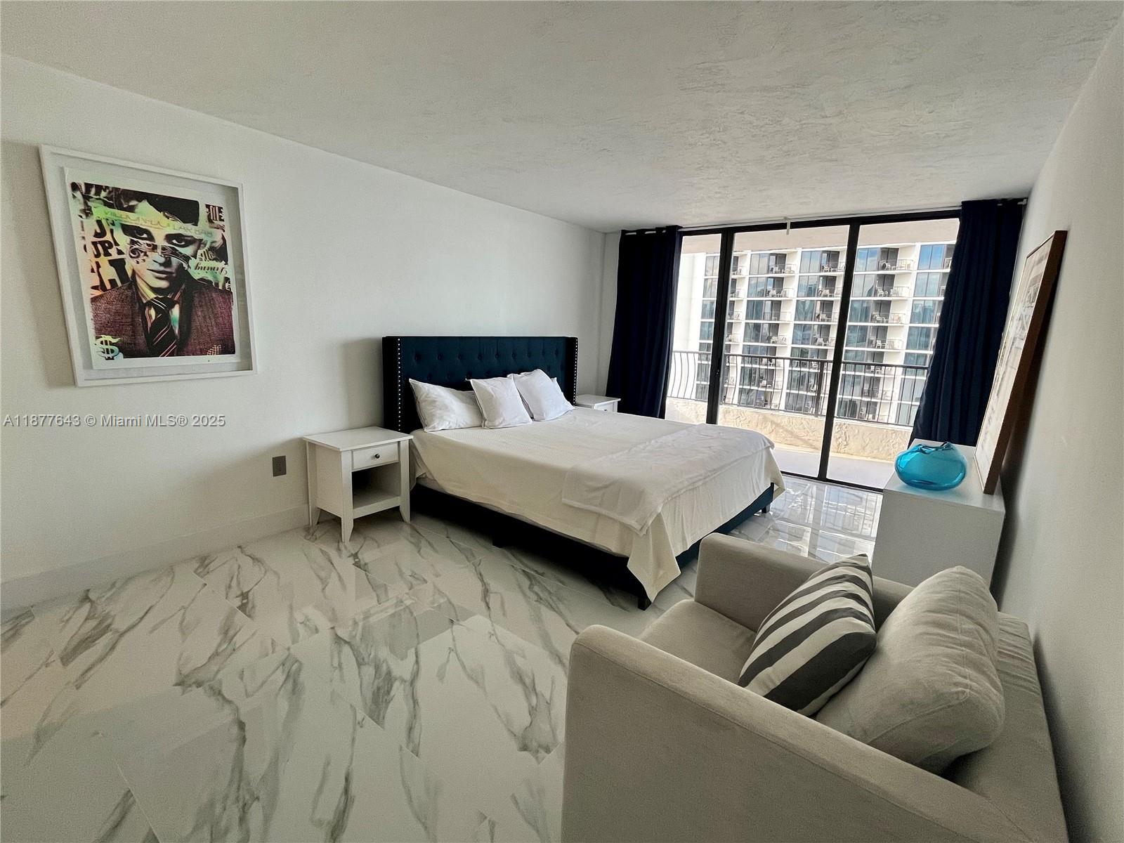 555 Northeast 15th Street, Unit 15G Miami, FL 33132 - Photo 42 of 61 a bedroom with a bed and glass window