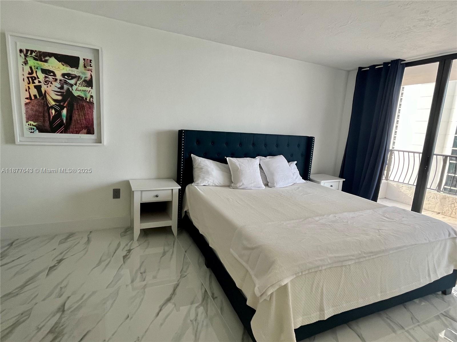 555 Northeast 15th Street, Unit 15G Miami, FL 33132 - Photo 44 of 61 a bedroom with a bed and a window