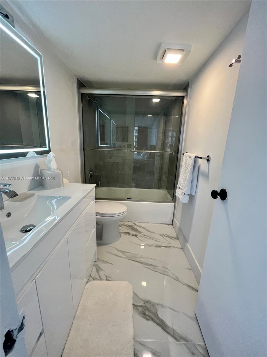 555 Northeast 15th Street, Unit 15G Miami, FL 33132 - Photo 45 of 61 a bathroom with a sink toilet and mirror