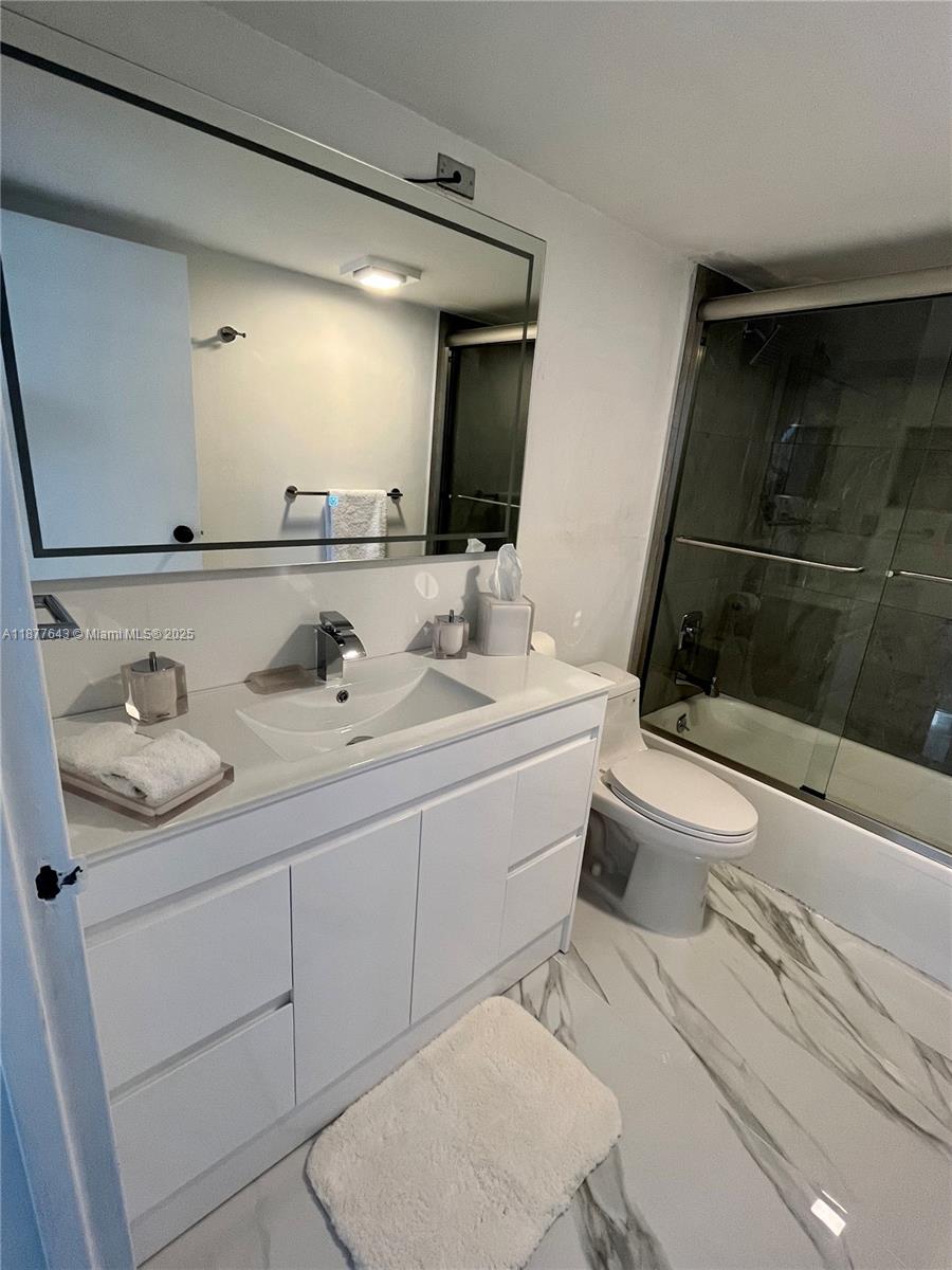 555 Northeast 15th Street, Unit 15G Miami, FL 33132 - Photo 48 of 61 a bathroom with a sink a toilet and shower