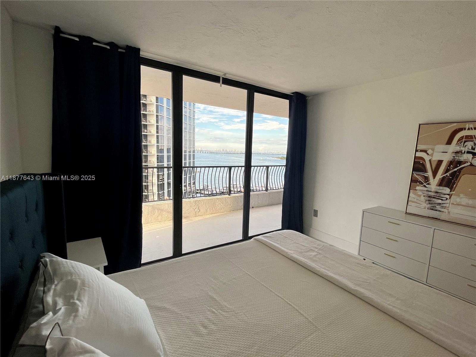 555 Northeast 15th Street, Unit 15G Miami, FL 33132 - Photo 49 of 61 a bedroom with a bed and a large window