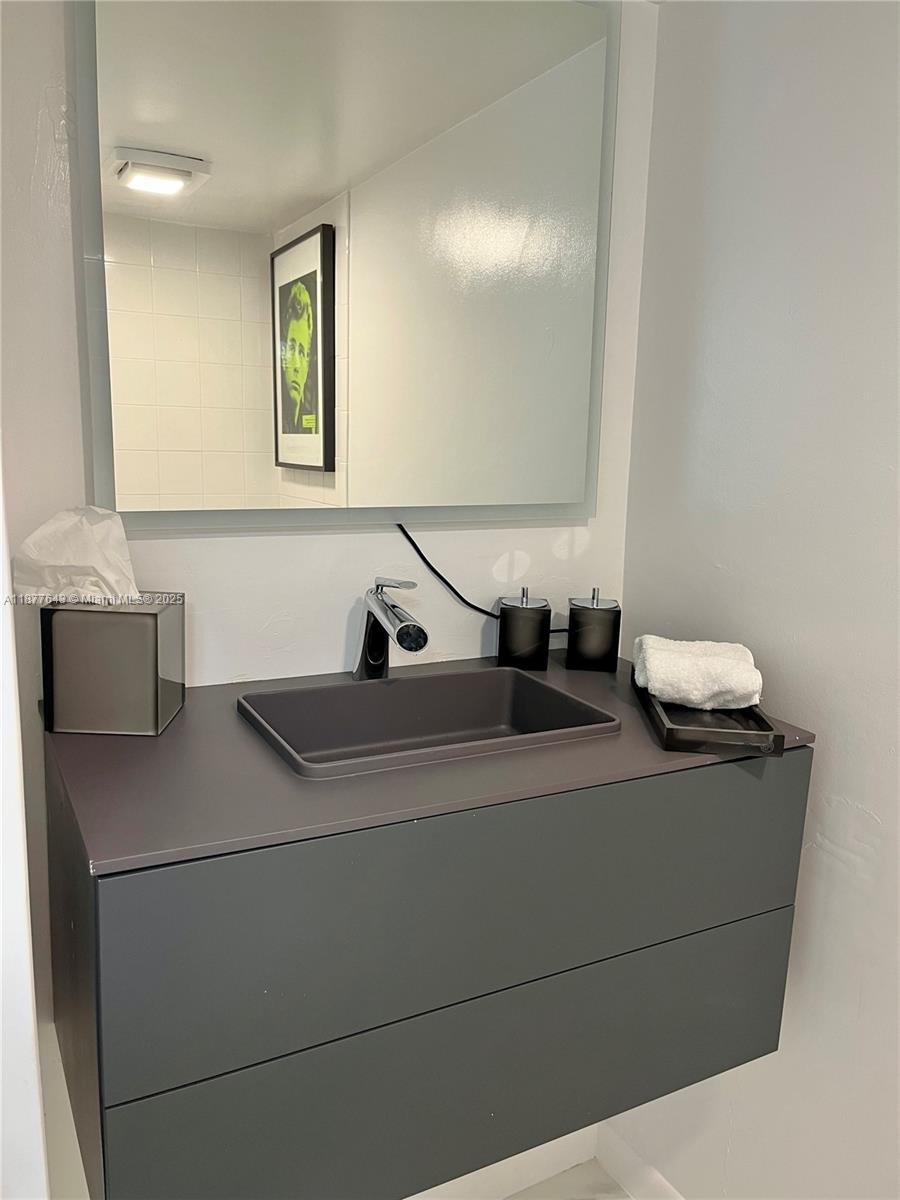 555 Northeast 15th Street, Unit 15G Miami, FL 33132 - Photo 53 of 61 a bathroom with a sink and a mirror