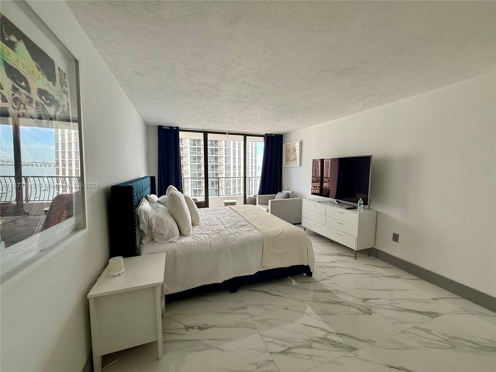 555 Northeast 15th Street, Unit 15G Miami, FL 33132 - Photo 54 of 61 a living room with furniture and a flat screen tv