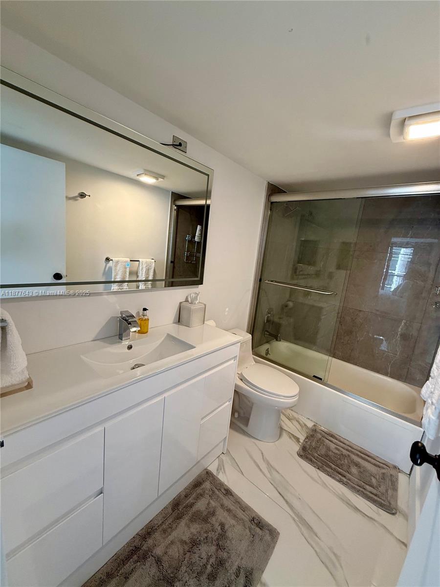 555 Northeast 15th Street, Unit 15G Miami, FL 33132 - Photo 56 of 61 a bathroom with a sink a toilet and shower