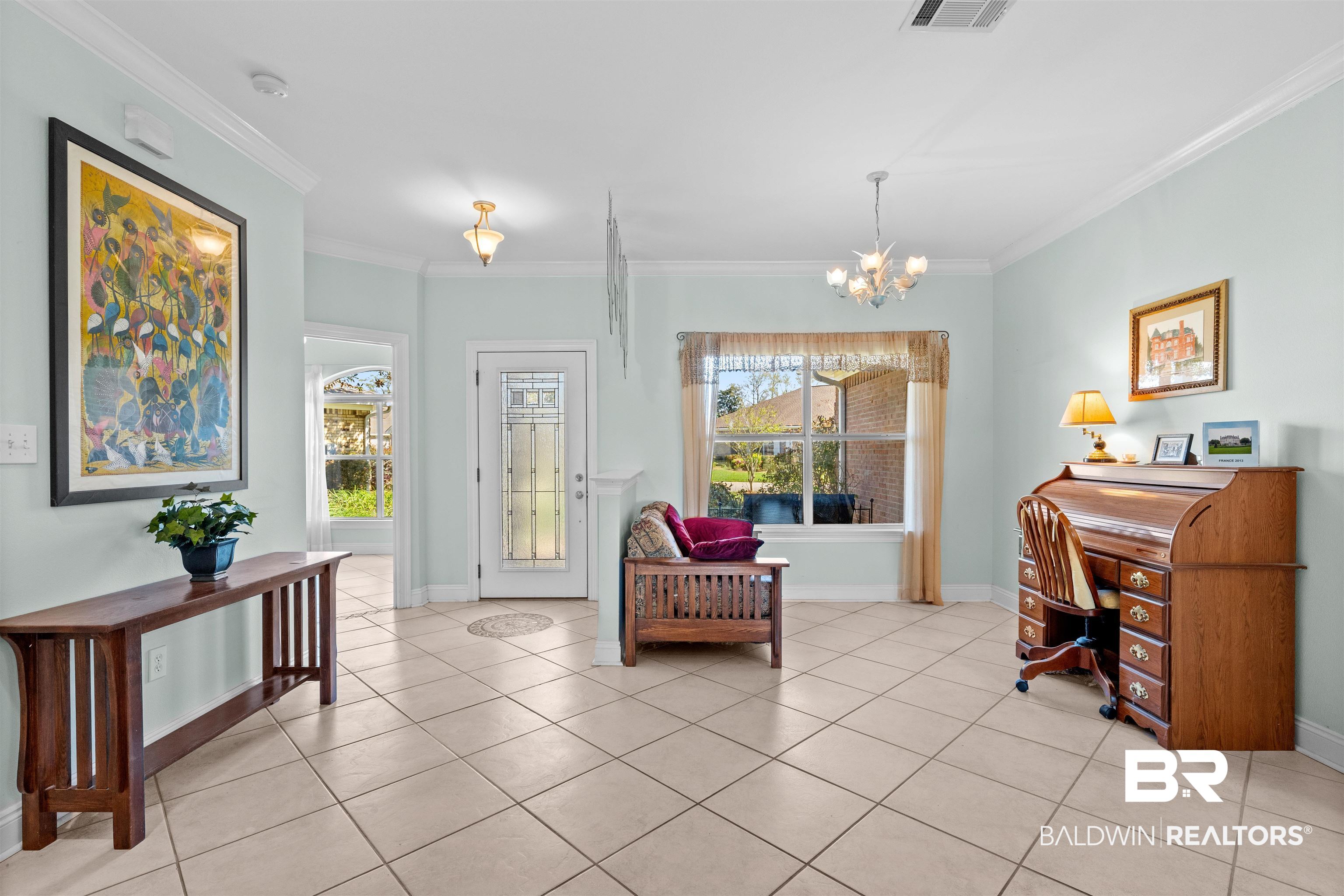 237 Hemingway Loop Foley, AL 36535 - Photo 3 of 49 Sitting room with a notable chandelier, a healthy amount of sunlight, light tile patterned floors, and ornamental molding