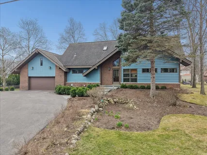 a front view of a house with a garden