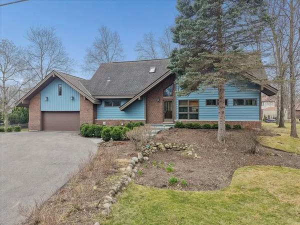a front view of a house with a garden