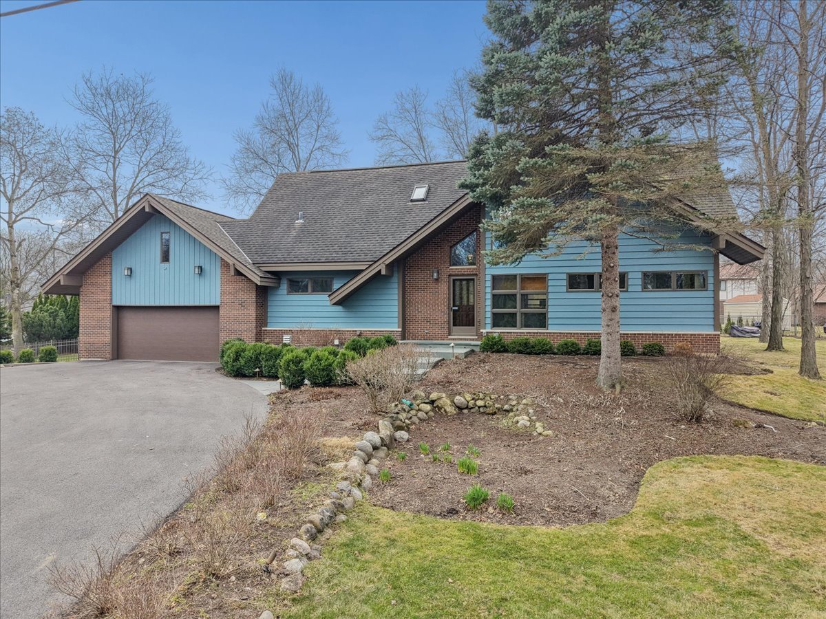131 West Everett Road Lake Forest, IL 60045 - Photo 1 of 43 a front view of a house with a garden