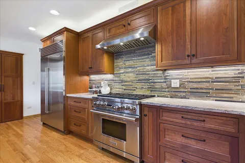 a kitchen with stainless steel appliances granite countertop a stove and a refrigerator