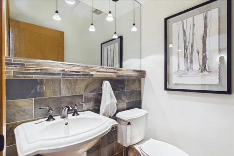 a bathroom with a sink a mirror and a toilet