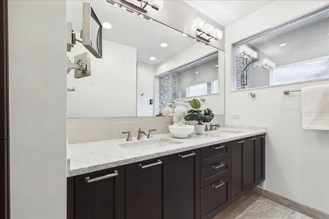 a bathroom with a sink double vanity and a mirror