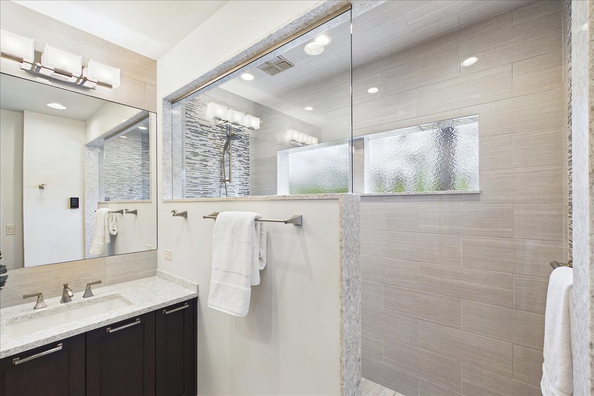 131 West Everett Road Lake Forest, IL 60045 - Photo 16 of 43 a bathroom with a sink a large mirror and shower
