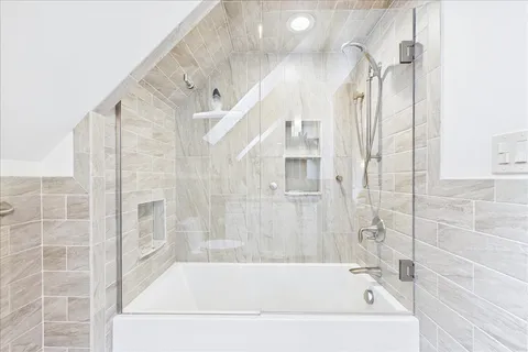 a bathroom with a bathtub and shower