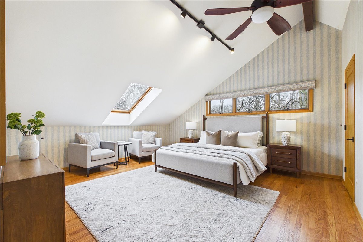 131 West Everett Road Lake Forest, IL 60045 - Photo 29 of 43 a spacious bedroom with a bed a chandelier and a window