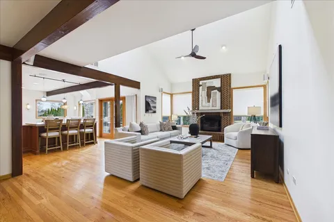 a living room with fireplace furniture and a wooden floor