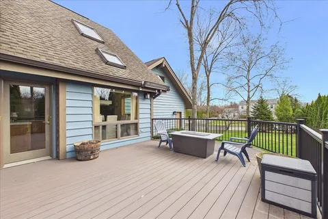 a view of a deck with furniture and wooden fence