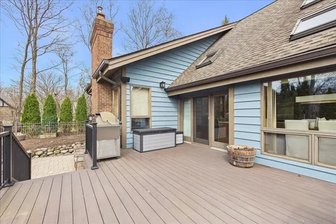 a view of a patio with table and chairs with wooden floor and fence